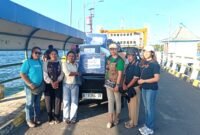 Elisabeth Donna Margareth Sine (Kaos Hijau) saat menyerahkan bantuan kepada relawan di Pelabuhan Feri Kewapante untuk dibawa ke korban gempa Flores di Pulau Palu'e.